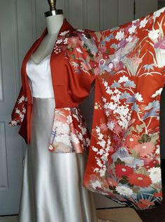 Created from a genuine Japanese kimono. Made to be worn open over a dress or tops. Fitted around the waist and flared peplum to create hour glass look.  Amazing Japanese floral print throughout. Cherry blossoms, Camelia, Roses, Daisies etc.  Full Japanese silk fabric. Including lining.  Perfect for your wedding day, or special outings. Modern Japanese Dress, Japanese Bride Modern, Festive Embroidered Wedding Kimono, Spring Wedding Kimono With Floral Embroidery, Yyh Kurama, Luxury Red Ceremonial Kimono, Japanese Wedding Kimono, Japanese Bride, Traditional Red Printed Kimono