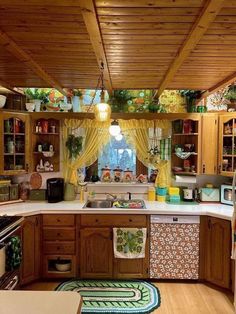 a kitchen with wooden cabinets and yellow curtains