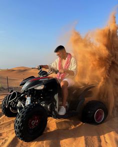 a man riding an atv in the desert