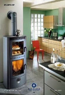 a kitchen with green walls and an oven in the middle