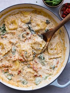 a skillet filled with chicken and dumplings on top of a white countertop