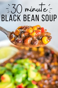 a spoon full of black bean soup with avocado and cilantro on the side