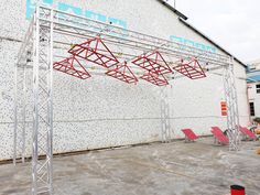 an outdoor stage set up with red chairs