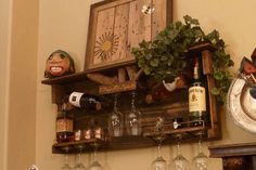 a shelf with wine glasses and bottles on it