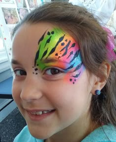 Rainbow Cheetah Face Paint, Jungle Face Paint Kids, Cheek Art Face Paint, Pride Face Painting, Uv Face Paint Ideas Simple, Lisa Frank Face Paint, Line Buster Face Paint, Bluey Face Painting Ideas For Kids, Lisa Frank Party Ideas