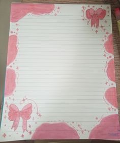 a notepad with pink bows and stars on it, next to a marker pen