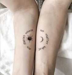 two people with matching tattoos on their arms, one has a sun and the other has a moon