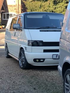 a white van is parked next to another car