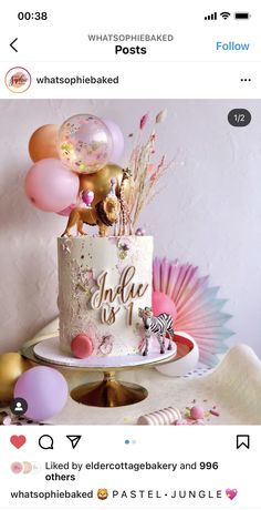 a white cake with pink and gold decorations