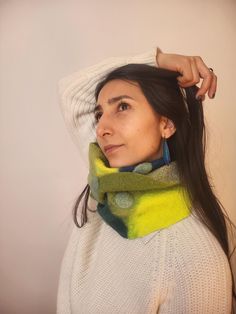 This Infinity Scarf brings earthy greens and intricate felted patterns to your wardrobe. Made from soft Merino wool and delicate silk, this unique accessory blends the luxurious warmth of wool with the gentle sheen of silk, creating an eye-catching and comfortable piece. Crafted with the Nuno felting technique, each fiber is fused seamlessly, resulting in a lightweight, breathable scarf that drapes elegantly. Merino wool's natural properties provide warmth, moisture-wicking, and softness against the skin, while the silk adds a subtle texture and a refined sheen. Each scarf is individually handmade, ensuring that no two are exactly alike--this piece is a one-of-a-kind addition to any wardrobe. Earthy Greens, Hand Felted, Nuno Felting, Neck Wrap, Felted Wool, Double Face, Wool Scarf, Accessories Unique, Infinity Scarf