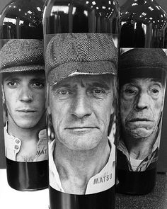 three bottles of wine with the faces of two men and one woman in hats on them