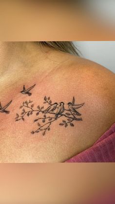 a woman's back shoulder with birds and flowers tattoo on her left side chest