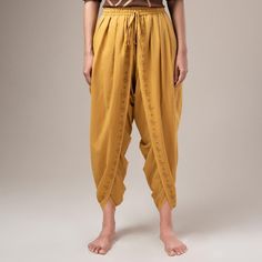 Get Mahashivaratri ready with Isha Life's bestseller unisex Dhoti pants. A popular choice among the Isha meditators, this versatile piece is stylish and comfortable. Made with 100% cotton, this ochre dhoti pant features the snake and vilva tonal print on its border. It has an elasticated waistband with a convenient fastener that allows you to experience the timeless charm of a classic dhoti in a ready-to-wear avatar. Harem Yoga Bottoms For Festivals, Harem Bottoms For Yoga And Festivals, Traditional Cotton Pants For Festivals, Traditional Harem Pants For Meditation, Traditional Cotton Harem Pants For Navratri, Traditional Cotton Ankle-length Bottoms, Traditional Harem Pants For Navratri, Traditional Ankle-length Bottoms For Diwali, Traditional Summer Yoga Harem Pants