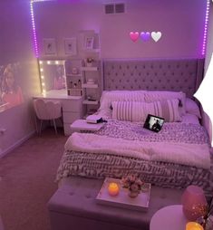 a bed room with a neatly made bed and purple lighting