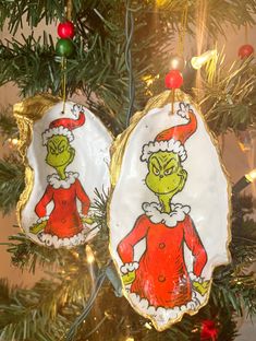 two christmas ornaments hanging from a tree