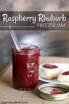 raspberry rhubarb freeze jam in a jar with a spoon next to it