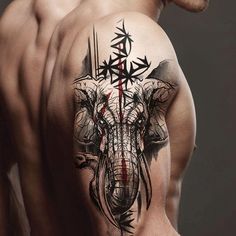 a man with an elephant tattoo on his back