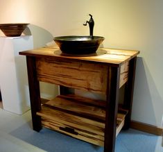 a bathroom sink sitting on top of a wooden table