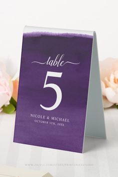 a purple table number card sitting on top of a table