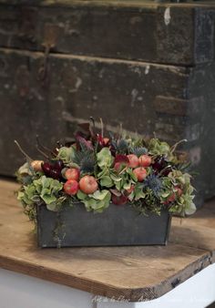 a wooden table topped with a potted plant