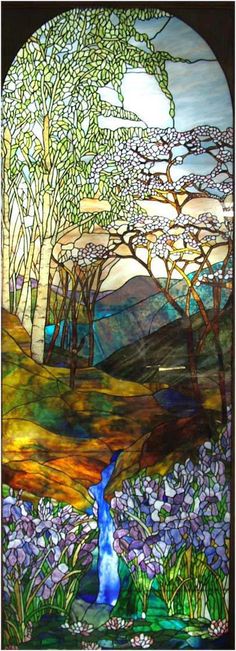 a stained glass window with trees and flowers in the foreground, surrounded by mountains