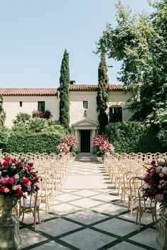 an outdoor ceremony set up with chairs and flowers