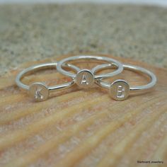 Sterling silver stacking ring with round disc and chosen initial.  Several can be worn together with different letters to each disc to create a name or initials.  The silver band has a polished finish. The silver disc is 5.2mm approx with 4mm letters   Price is for one ring.   UK finger sizes  J to T Other sizes available on request .   All my jewellery comes in a presentation gift box. Handmade in Cornwall. Simple stacking rings. A lovely simple mix of beads, blossoms, leaves, pearls and hearts with sterling silver, copper and brass  creating wonderful possibilities for beautiful combinations. Thank you for visiting my shop. Simple Stacking Rings, Silver Initial Ring, Gift Box Handmade, Sterling Silver Stacking Rings, Letter Ring, Ring Hand, Box Handmade, Silver Stacking Rings, Initial Ring