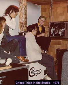 a group of people sitting in a living room together