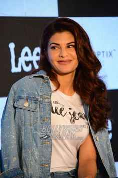 an image of a woman that is smiling for the camera and wearing a jean jacket