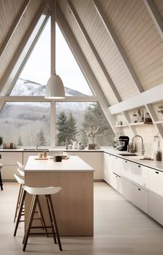 a kitchen with an island in the middle of it and two stools at the counter