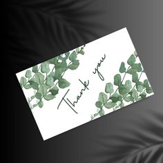 a thank card with green leaves on it