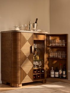 a wooden cabinet with wine glasses and bottles in it