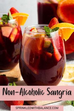 two glasses filled with sangria on top of a table