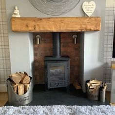 a living room with a fire place and lots of wood stacked on top of it