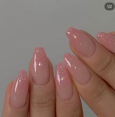 a woman's hand with pink manies and glitters on her nails,