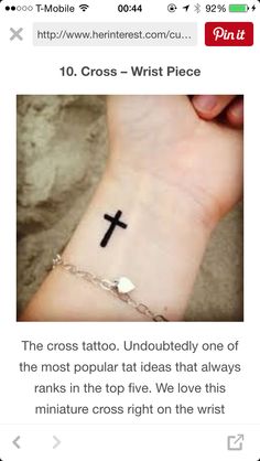 the cross tattoo is on someone's wrist, and it looks like they are going to