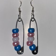 two pairs of blue, pink and white glass beads hang from silver earwires