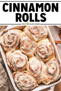 cinnamon rolls with icing in a white baking dish