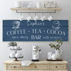 a wooden sign that says coffee, tea and cocoa on the side of a dresser