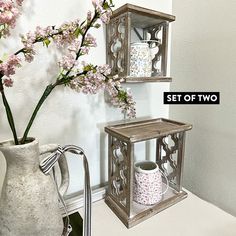 two vases with flowers in them sitting next to each other