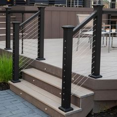 an outdoor deck with stairs and railings