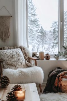 a living room filled with furniture next to a large window covered in blankets and pine cones