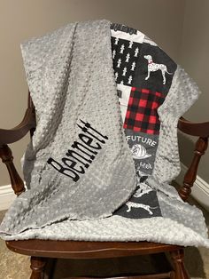 a chair with a blanket on top of it and a dog scarf hanging from the back