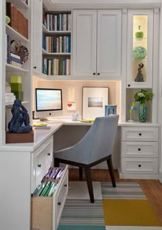 a home office with built in bookshelves and desk