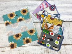 three sunflowers are on the table next to each other and one is made from fabric