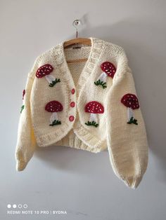 a knitted sweater with mushrooms on it