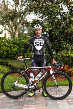 a man is standing next to his bike