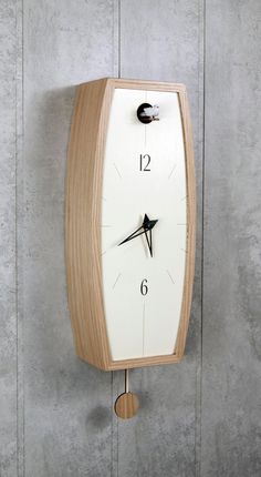 a wooden clock mounted to the side of a wall