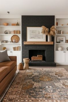 a living room filled with furniture and a large rug on top of a hard wood floor