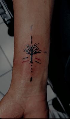 a person's foot with a tree tattoo on it